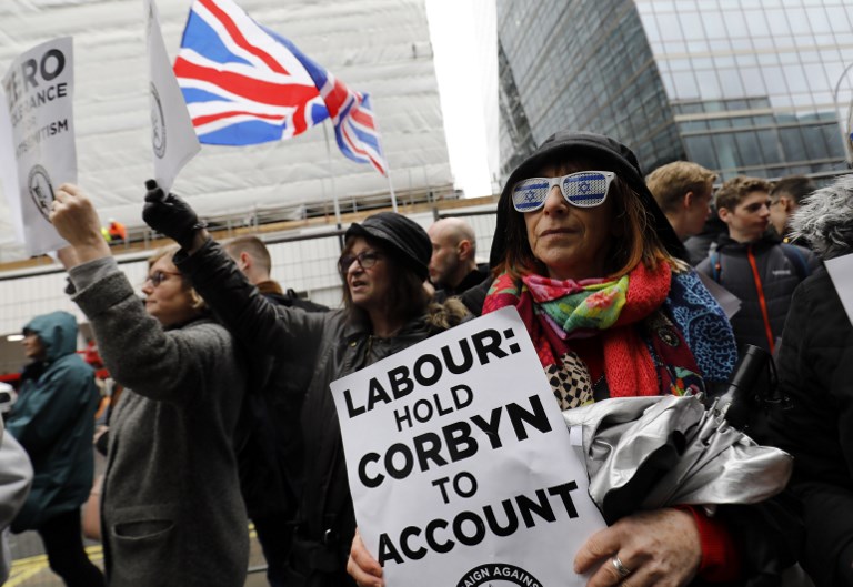Demonstrators gather outside Labour Party offices in London on 8 April 2018 (AFP)