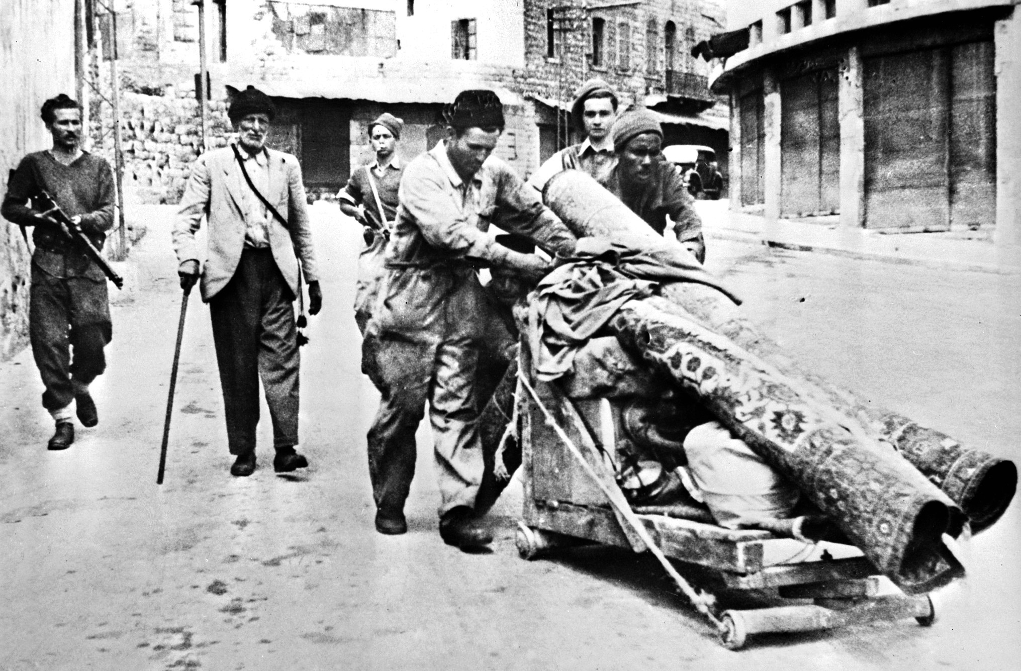 Members of the Haganah paramilitary escort Palestinians expelled from Haifa after Jewish forces took control in April 1948 (AFP/File photo)