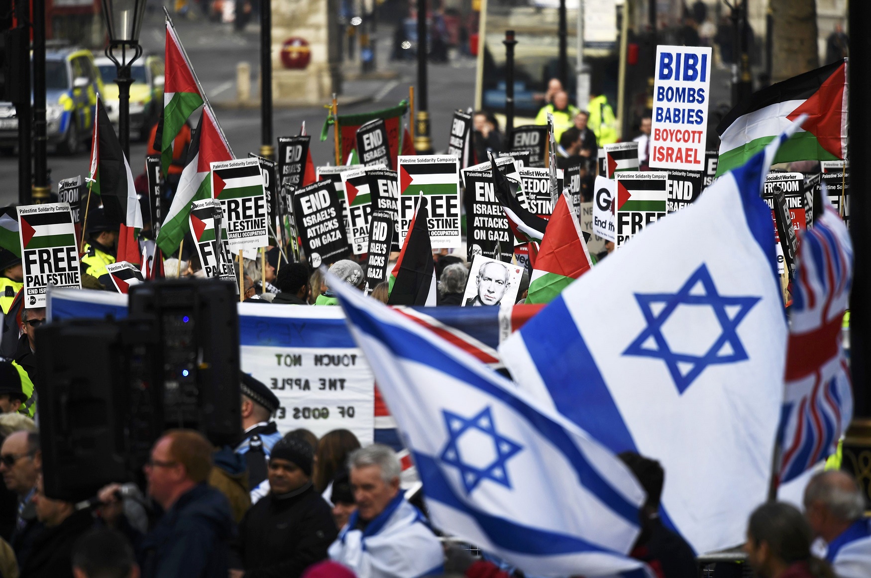 Pro-Palestinian protesters are flanked by supporters of Israel at protests near 10 Downing Street (Reuters)