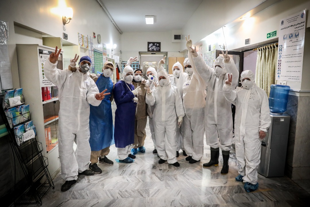 Nurses and doctors in the special unit for Covid-19 patients in Masih Daneshvari Hospital pose for a photo (MEE/Mohammadreza Abbassi)