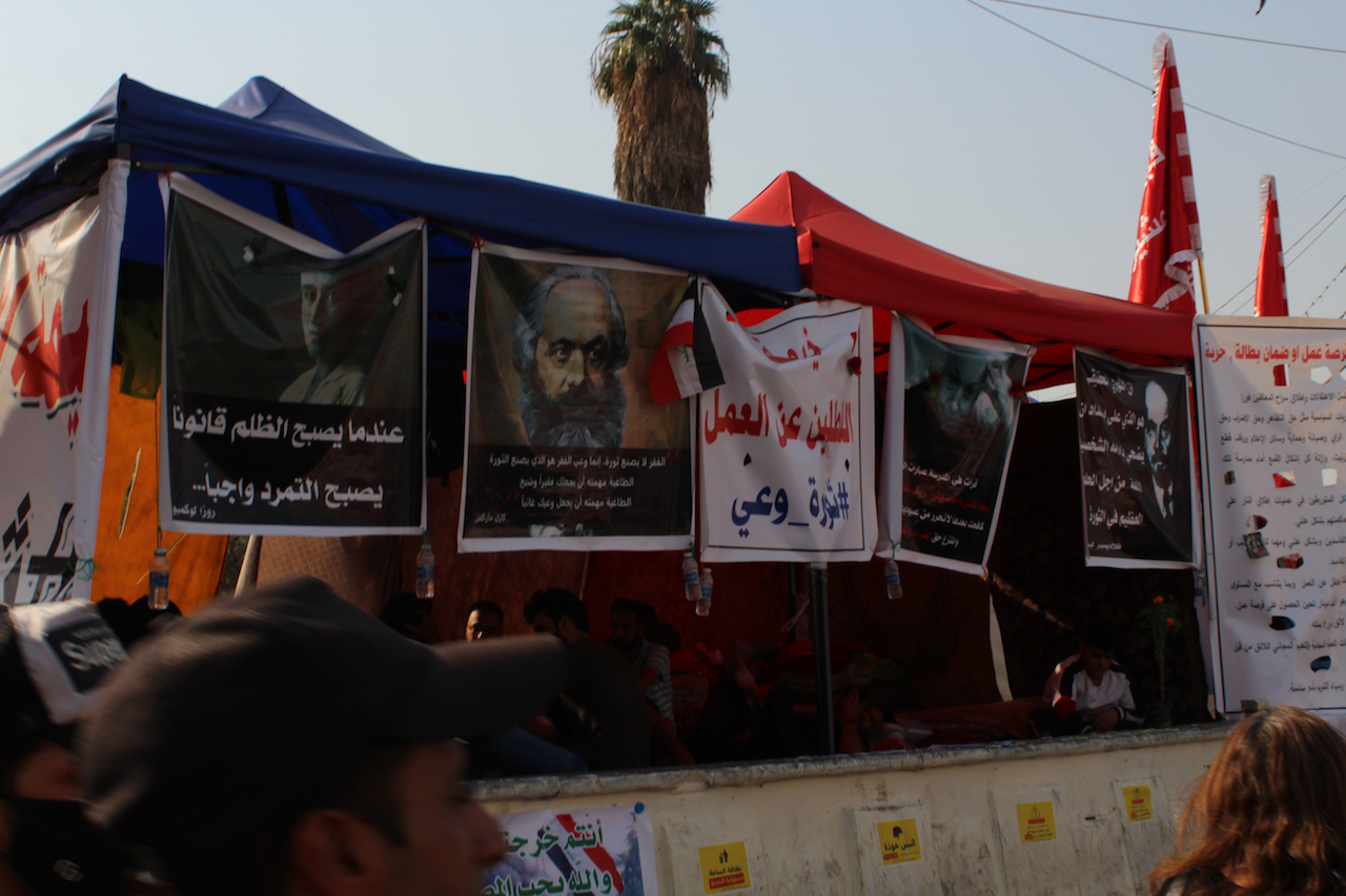 Posters depict Karl Marx, Rosa Luxemburg and other leftist figures in Tahrir Square (MEE/Alex MacDonald)