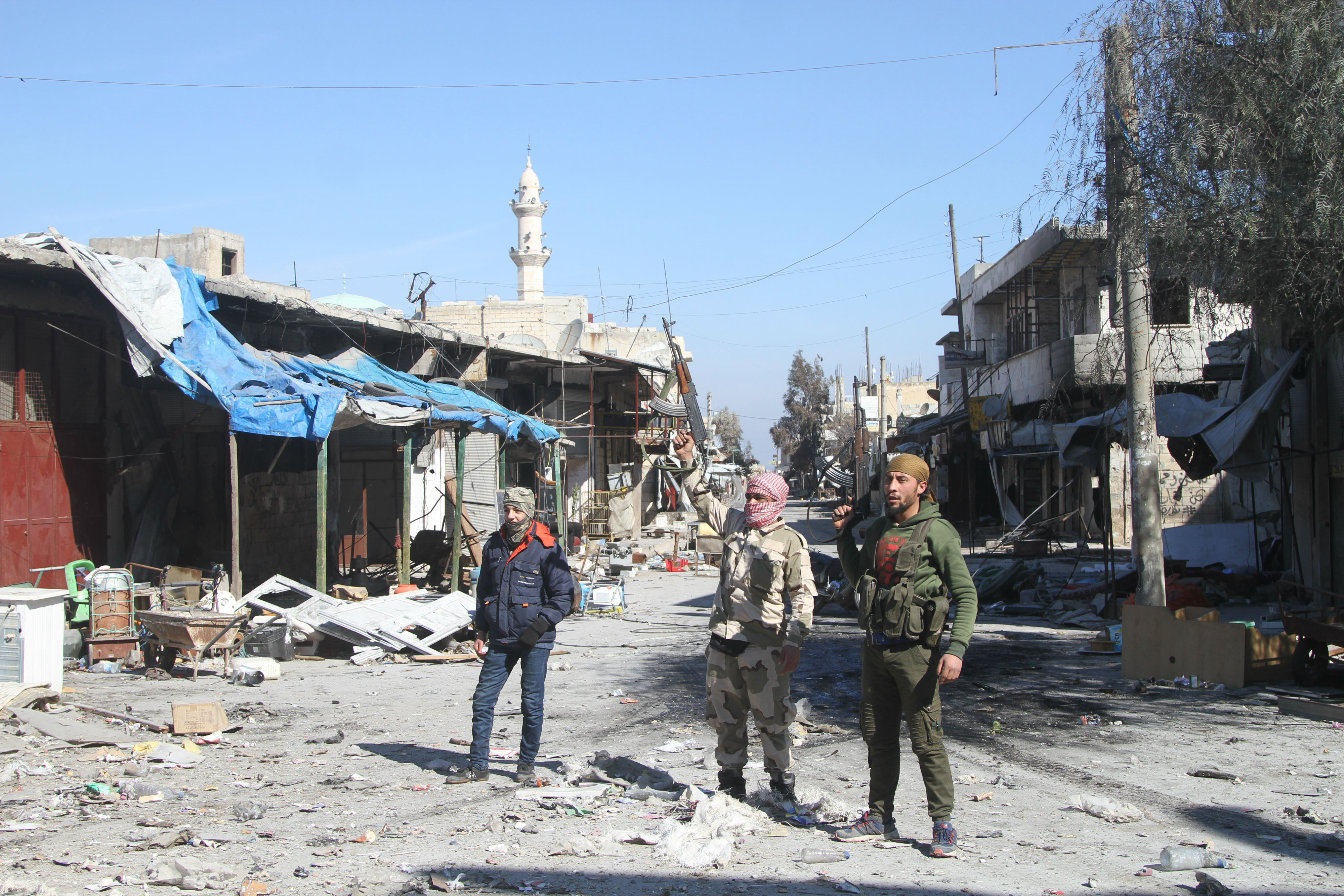 Rebel fighters stand in the Idlib town of Saraqeb (MEE/Abdulwajed Haj Esteifi)