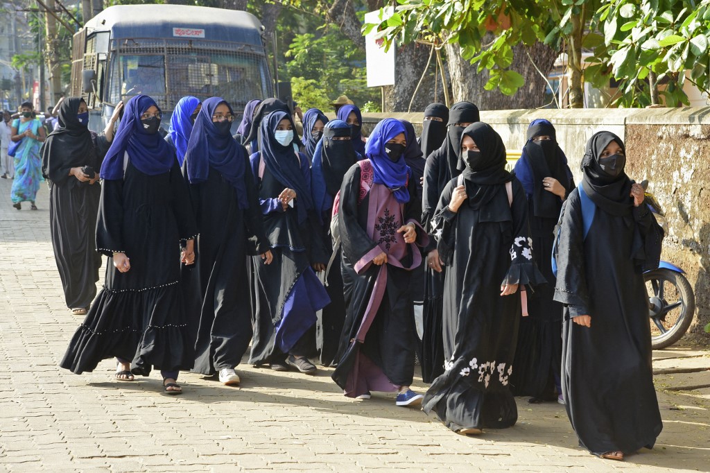 Students arrive at their college in India’s Karnataka state on 7 February 2022 (AFP)