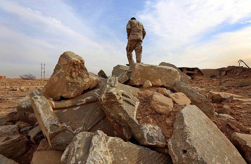 An Iraqi soldier stands among the ruins of Nimrud, pictured on 15 November (AFP)