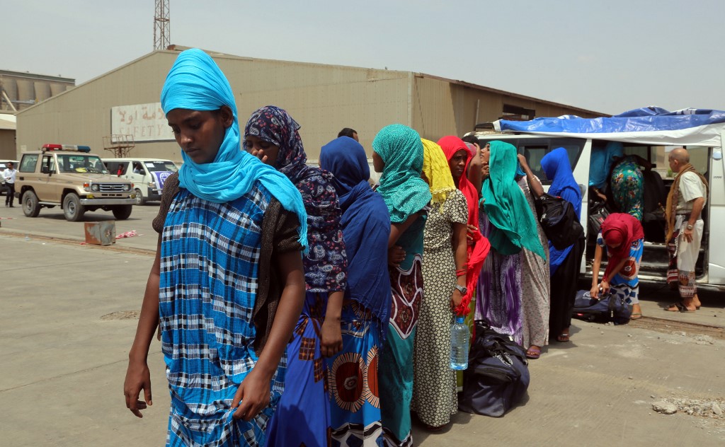 Ethiopian migrants queue to board a ship repatriating them home via Djibouti, in the Yemeni rebel-held Red Sea port of Hodeida on June 2, 2018.