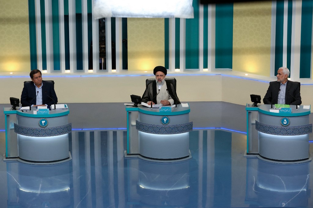 Presidential candidates Abdolnaser Hemmati, Raisi and Mohsen Mehralizadeh participate in a televised debate in Tehran on 12 June 2021 (AFP/Iranian Young Journalist Club)