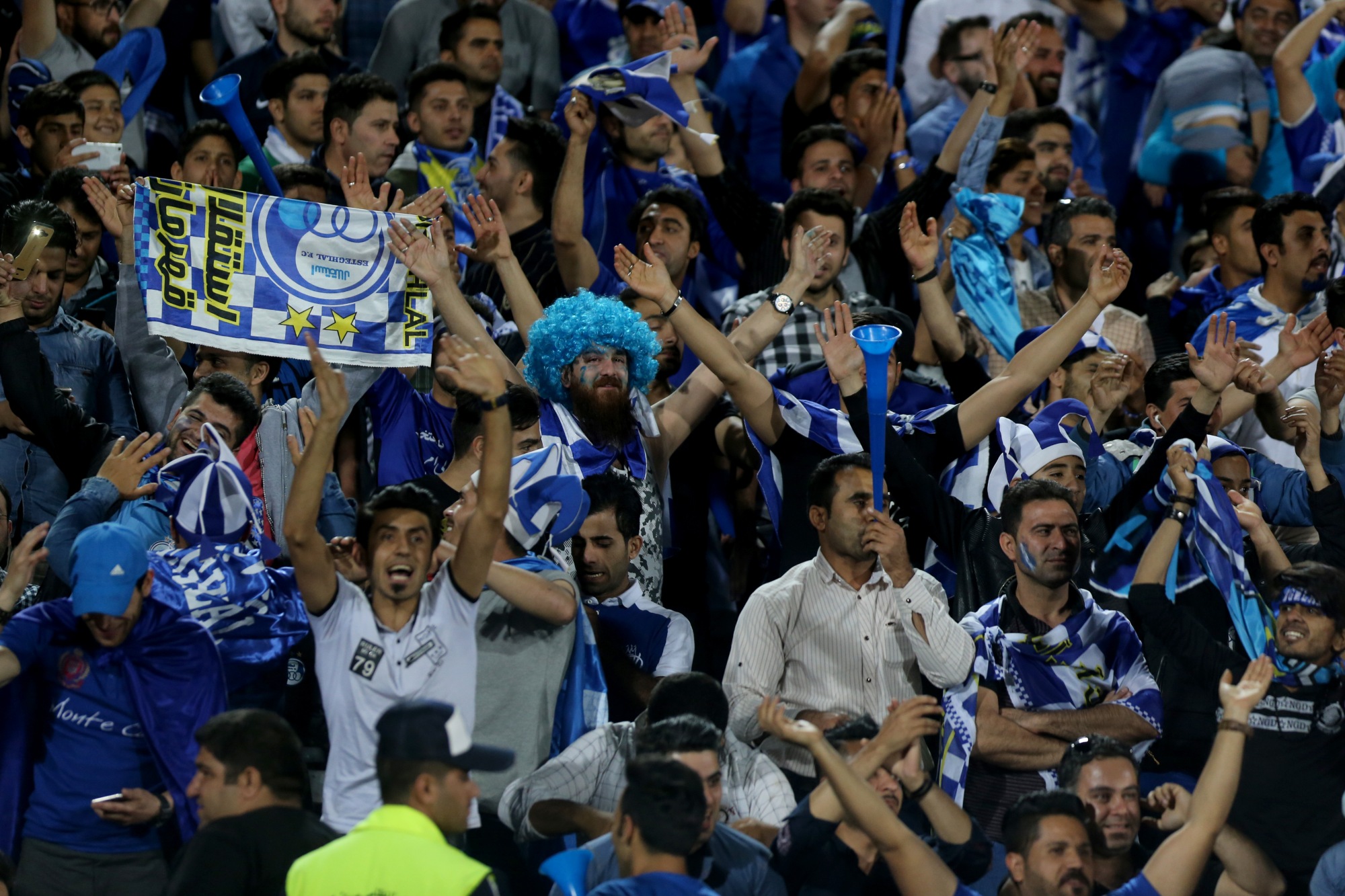Iranian Esteghlal FC club fans cheer during a 2018 AFC Champions League football match against Zobahan at the Azadi Stadium in Tehran (AFP)