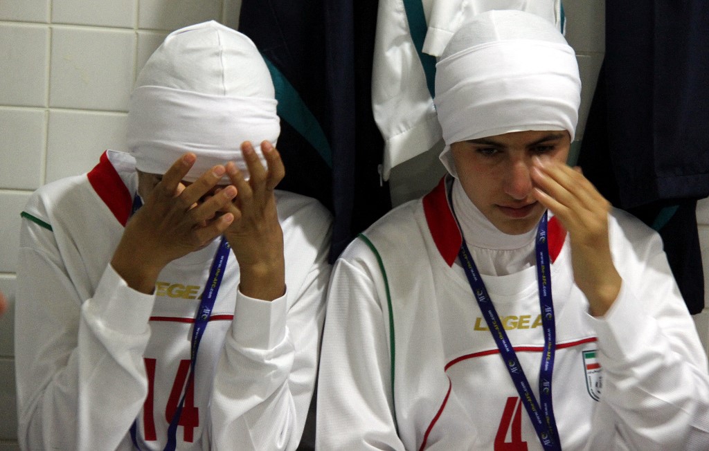 Two Iranian football players cry after being barred from an Olympic qualifier against Jordan for wearing the Islamic headscarf in 2011 (AFP/Mehr News)
