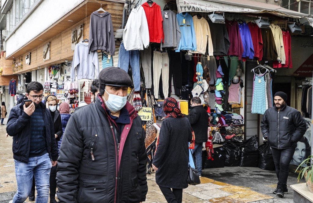 Mask-clad Iranians shop at the Tajrish Bazaar market in the capital Tehran, on January 16, 2022, during the coronavirus pandemic.