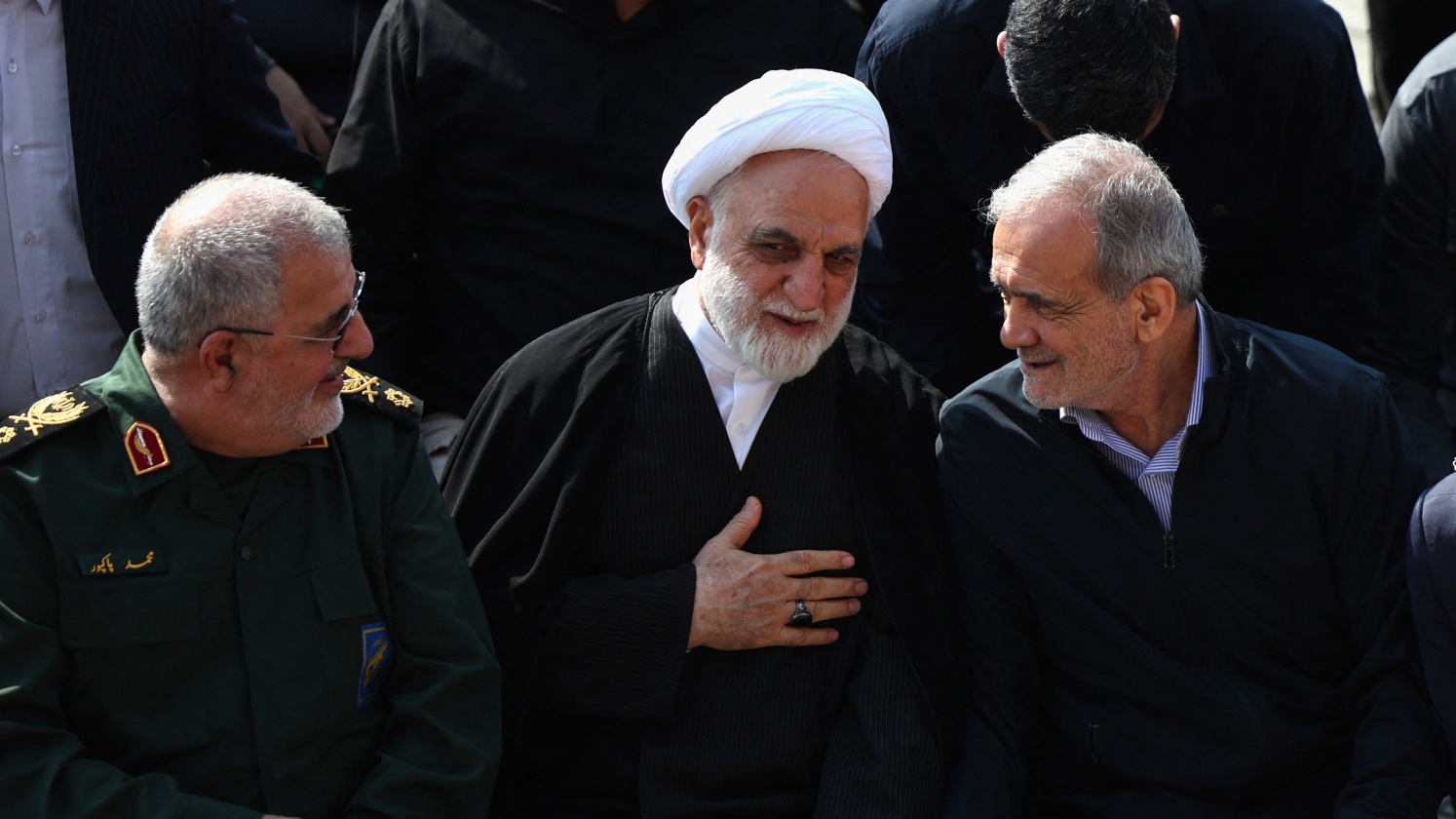 Qaani (L), seated next to Iranian judiciary chief Mohsen Ejeie (C) and Iranian President Masoud Pezeshkian at Tuesday's funeral (AFP).