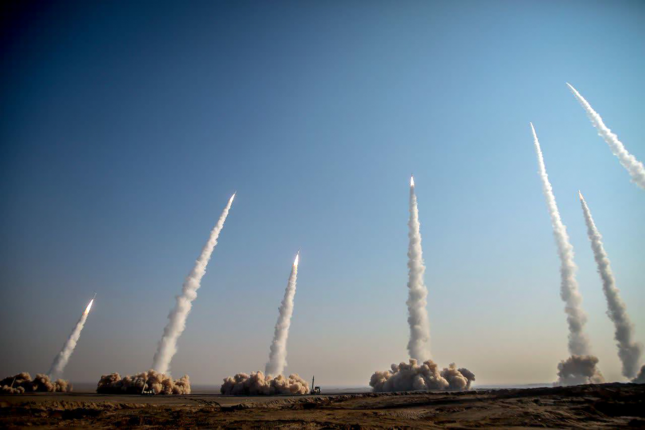 Several missiles are seen being being launched in a desert area in Iran on Friday (AFP) 