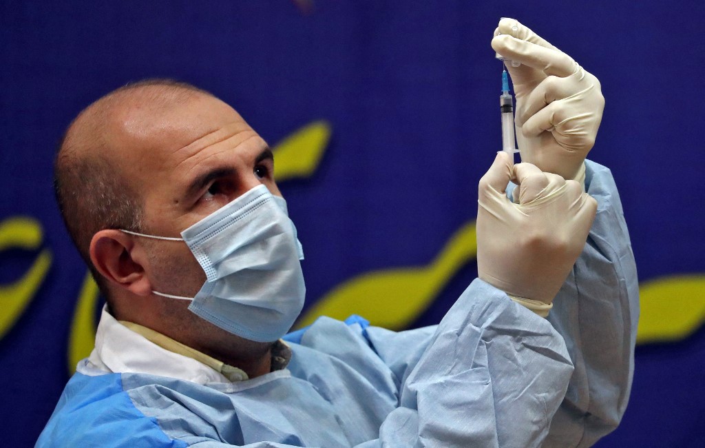 An Iranian health worker prepares a dose of the COVID-19 vaccine as the country launches its inoculation campain, at the Imam Khomeini hospital in the capital Tehran, on February, 9, 2021.