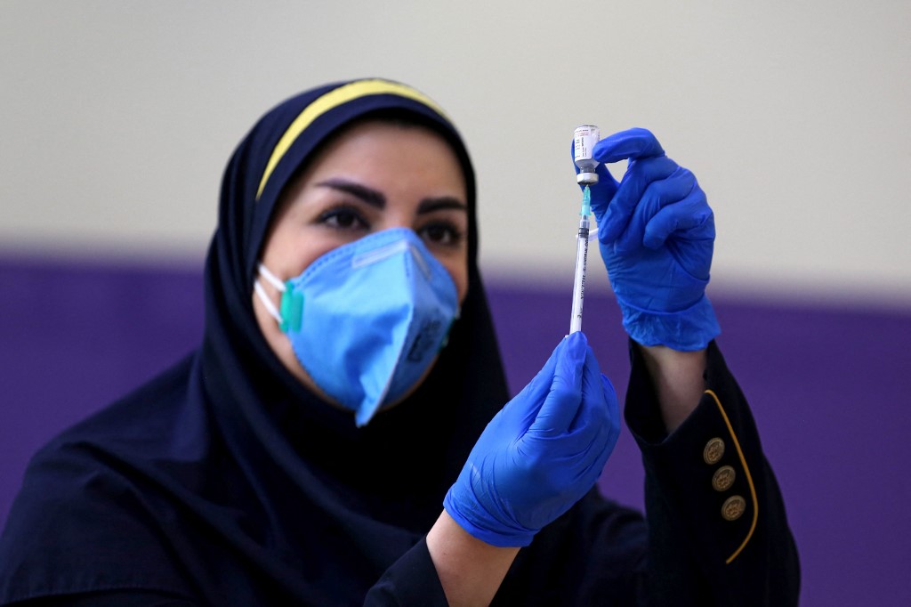 An Iranian health worker prepares an injection of the locally-made COVID-19 vaccine during the start of the second phase of trials in the capital Tehran on March 15, 2021.