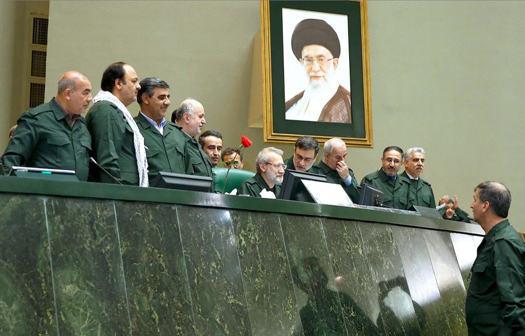 Members of parliament wear IRGC uniforms in Tehran on 9 April (AFP)