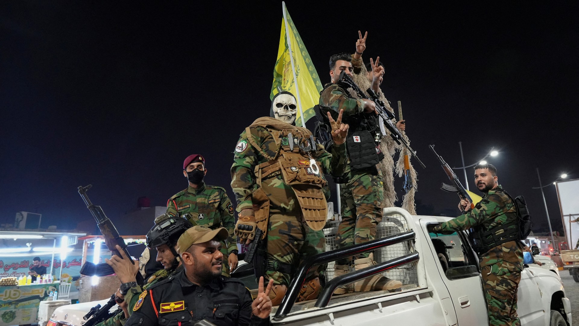 Iraqi fighters celebrate on a street, after the Iranian missile attack on Israel, in Basra, 1 October (Reuters/Essam al-Sudani)