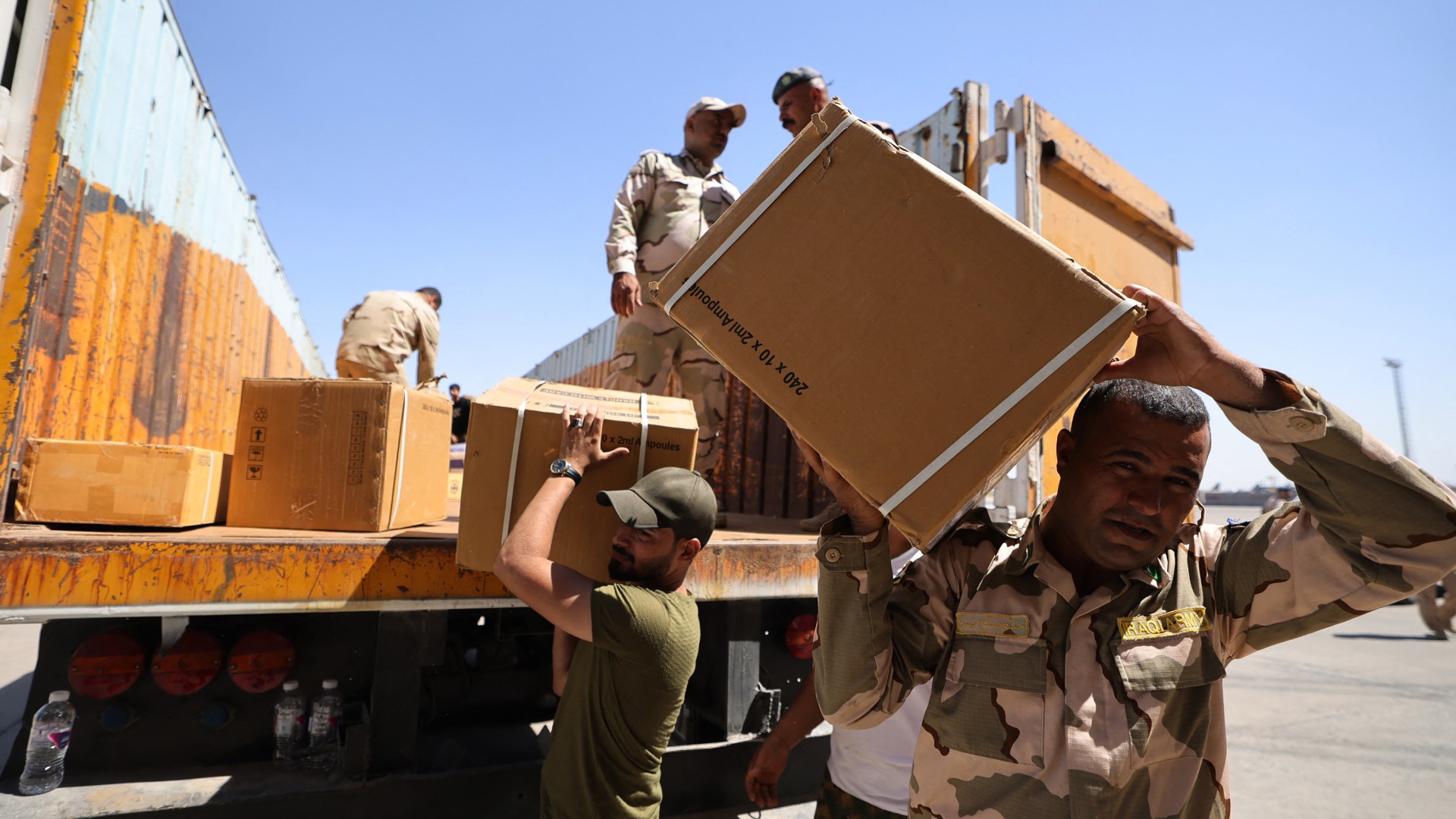 Iraqi soldiers prepare a shipment of emergency medical aid, destined to Lebanon, at the Baghdad International Airport on 19 September (AFP/Ahmad al-Rubaye)