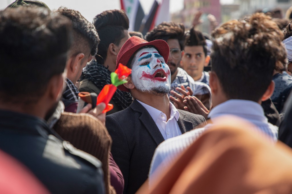 An Iraqi demonstrator dressed in a Joker outfit attends an anti-government protest in the southern city of Basra on 11 February (AFP)