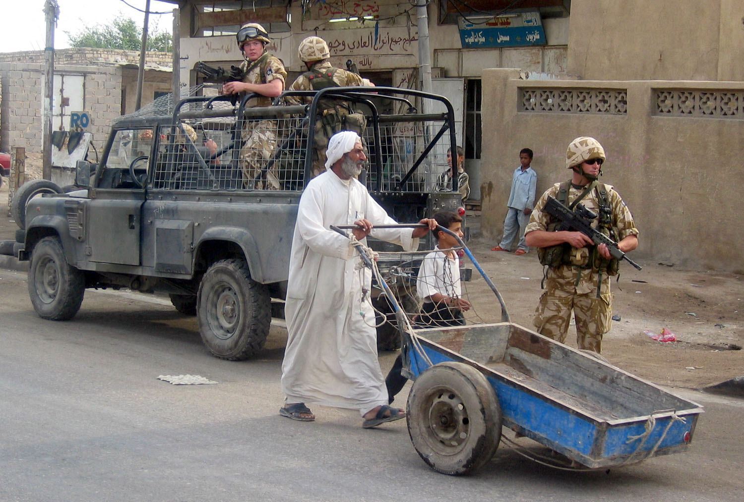 British soldiers patrol a main road in Basra 10 November, 2003 (AFP)
