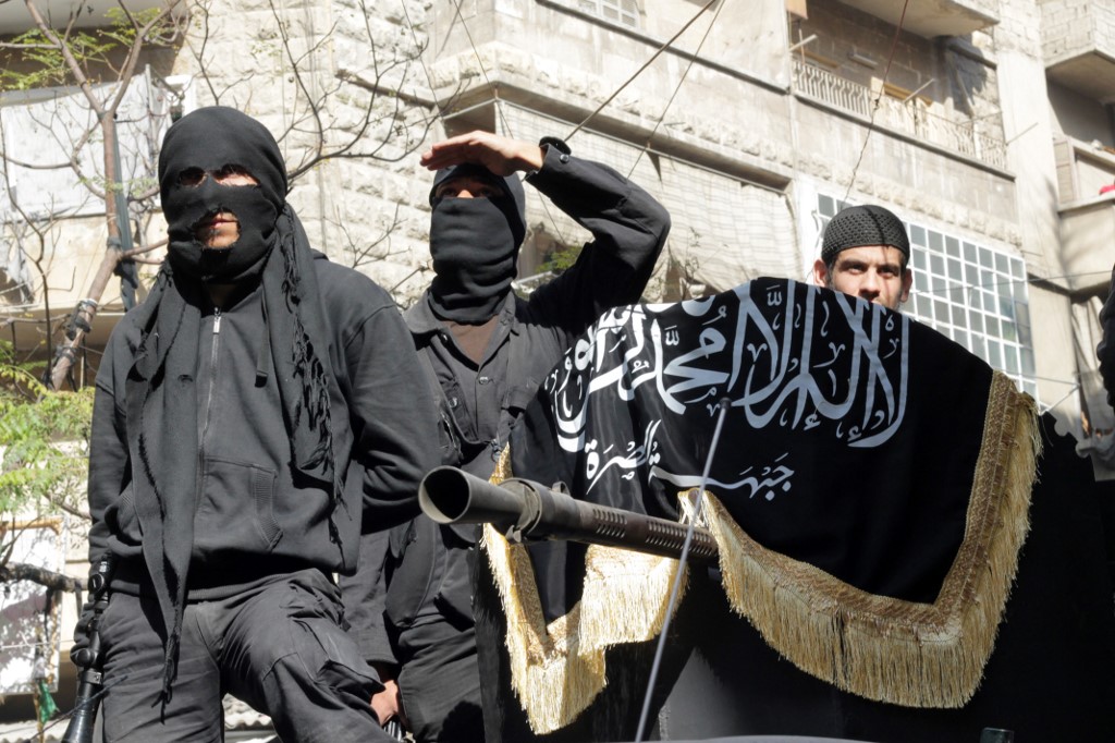 Members of jihadist group Al-Nusra Front take part in a parade calling for the establishment of an Islamic state in Syria, at the Bustan al-Qasr neighbourhood of Aleppo, on October 25, 2013. 