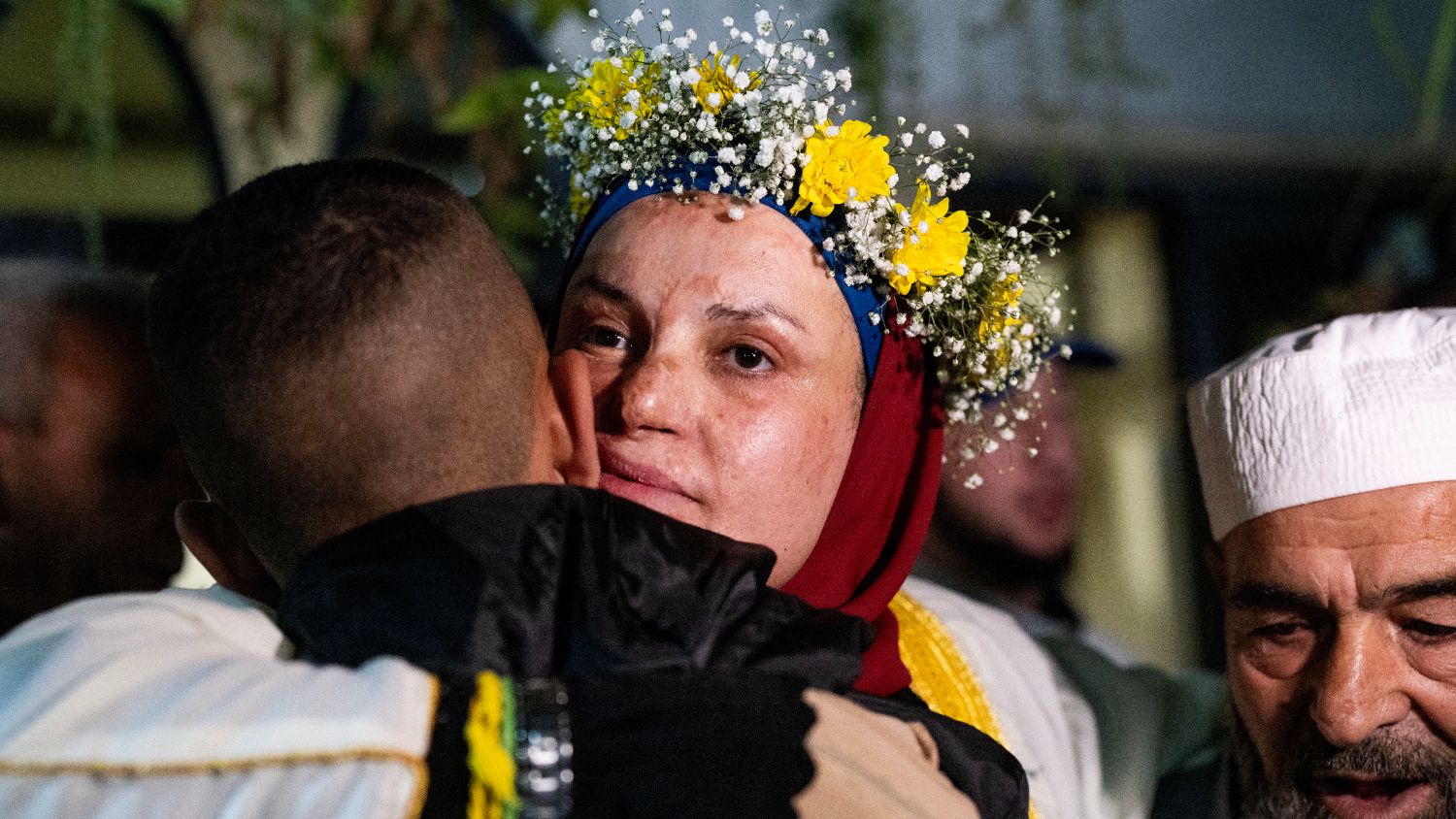 Prominent Palestinian prisoner Israa Jaabis (C) arrives at her home in Israeli-annexed East Jerusalem early on 26 November 2023.