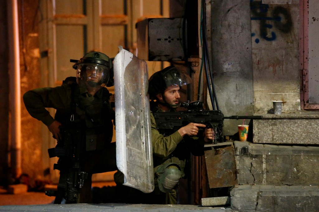 Israeli security forces position themselves in Hebron on 25 April 2021 (AFP)
