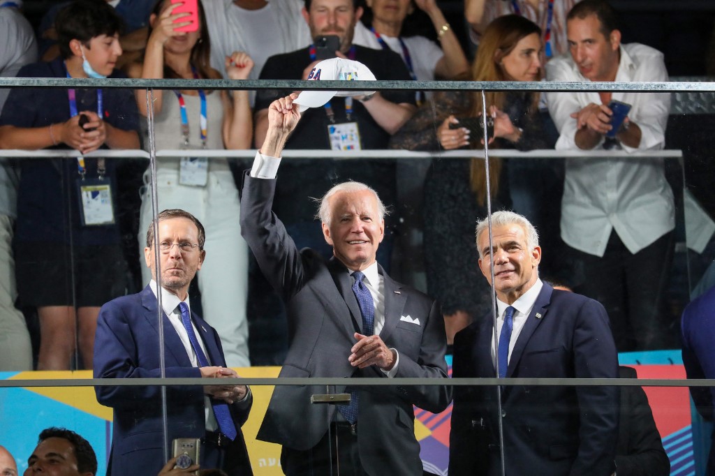 Biden is flanked by Israeli President Isaac Herzog and Prime Minister Yair Lapid in Jerusalem on 14 July 2022 (AFP)