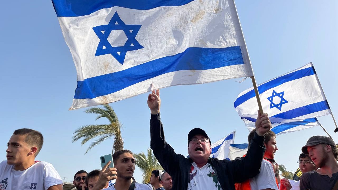 An Israeli man joins the Flag March outside Damascus Gate in Jerusalem on 29 May 2022. (MEE/Latifeh Abdellatif)