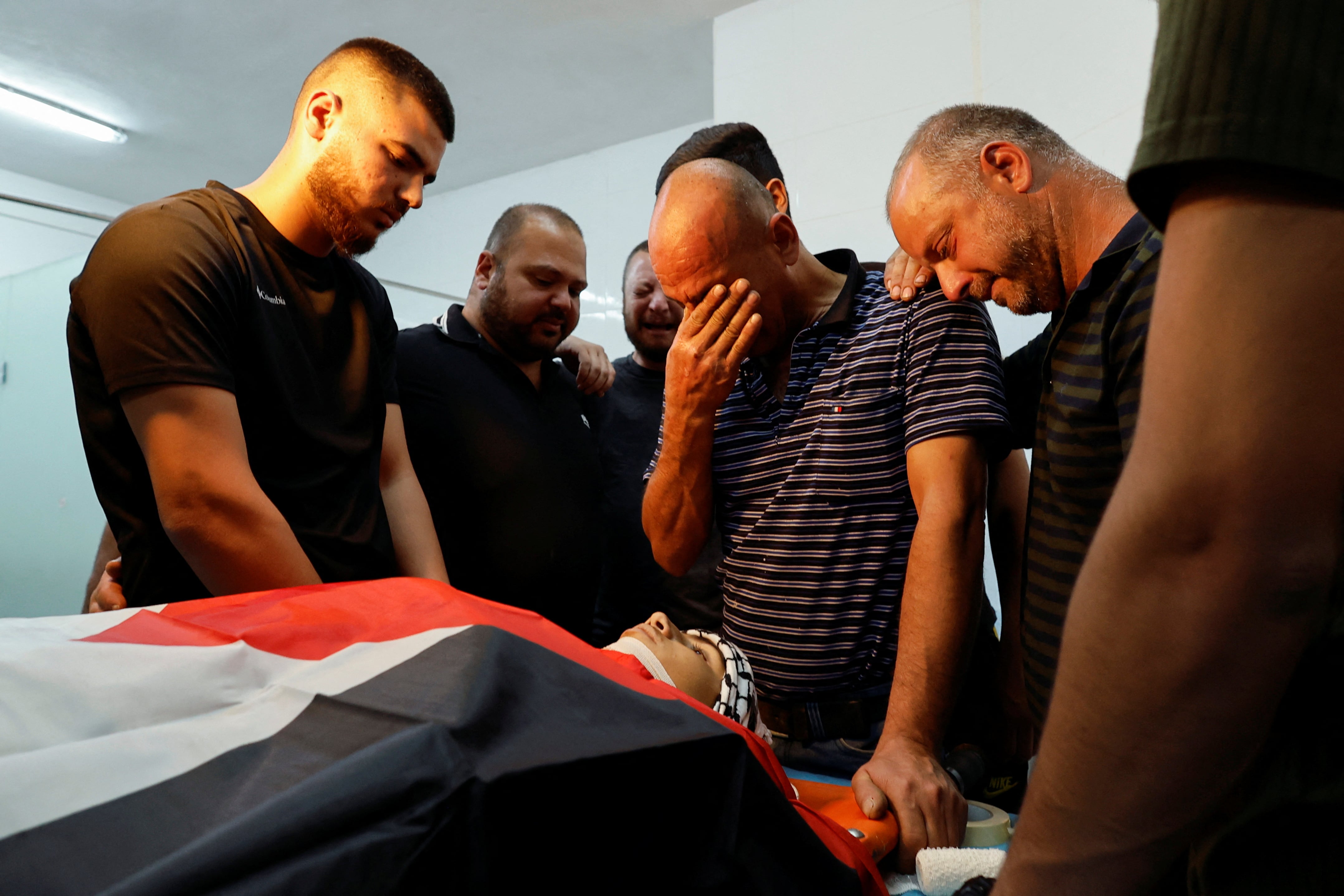 Mourners react next to the body of Palestinian teenager Zaid Ghonim before he was laid to rest in Bethlehem. (Reuters)