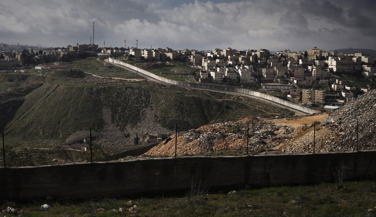 The controversial Israeli separation barrier between the Palestinian West Bank village of al-Ram (foreground, R) and the Israeli settlement of Neve Yaacov in East Jerusalem (L) (AFP)