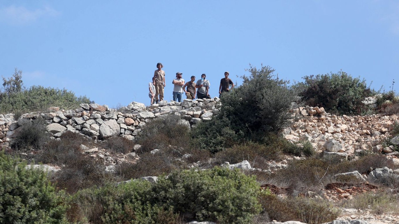 Israeli settlers gather in the West Bank village of Umm Safa on 26 September, 2024, as construction begins on levelling Palestinian land (Fayha Shalash/MEE) 