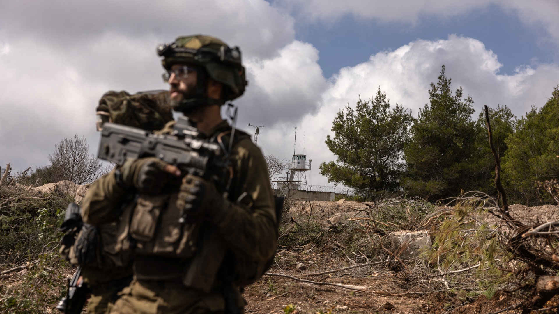  This picture taken on October 13, 2024 during a controlled embed organised by the Israeli military, shows Israeli troops patrolling near a United Nations Interim Force In Lebanon (UNIFIL) base in the southern Lebanon's Naqoura region near the border.