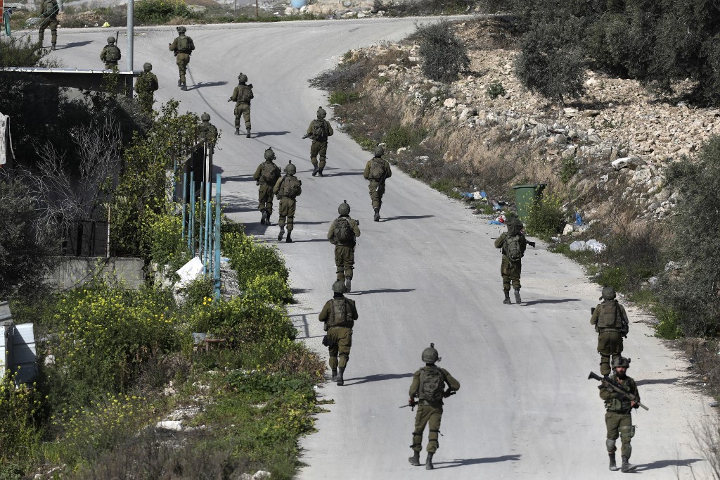 sraeli soldiers patrol a village south of Jenin in the occupied West Bank on 30 March 2022. (AfP)