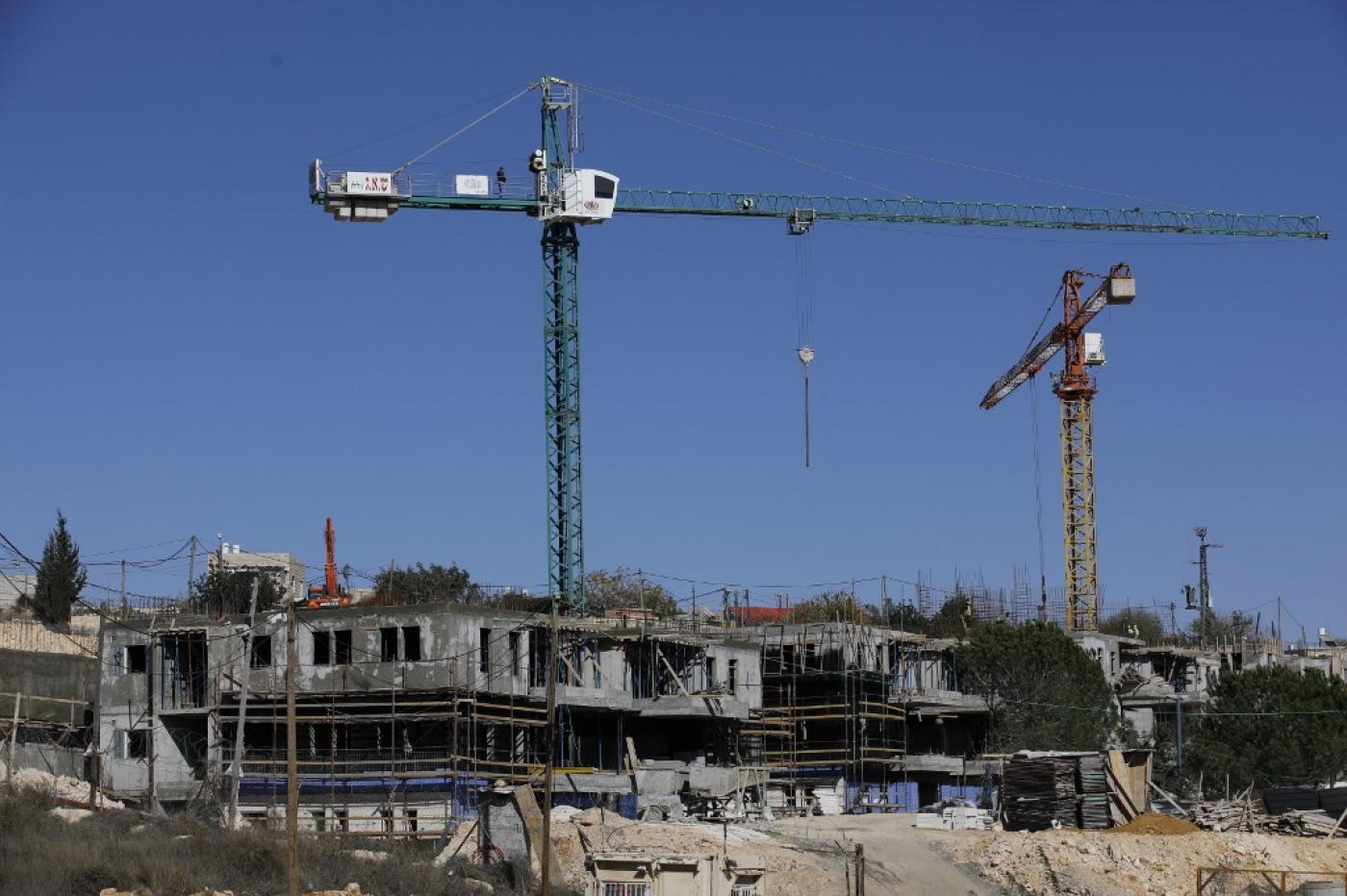 .Construction takes place at an illegal Israeli settlement near Bethlehem on 19 November (AFP)