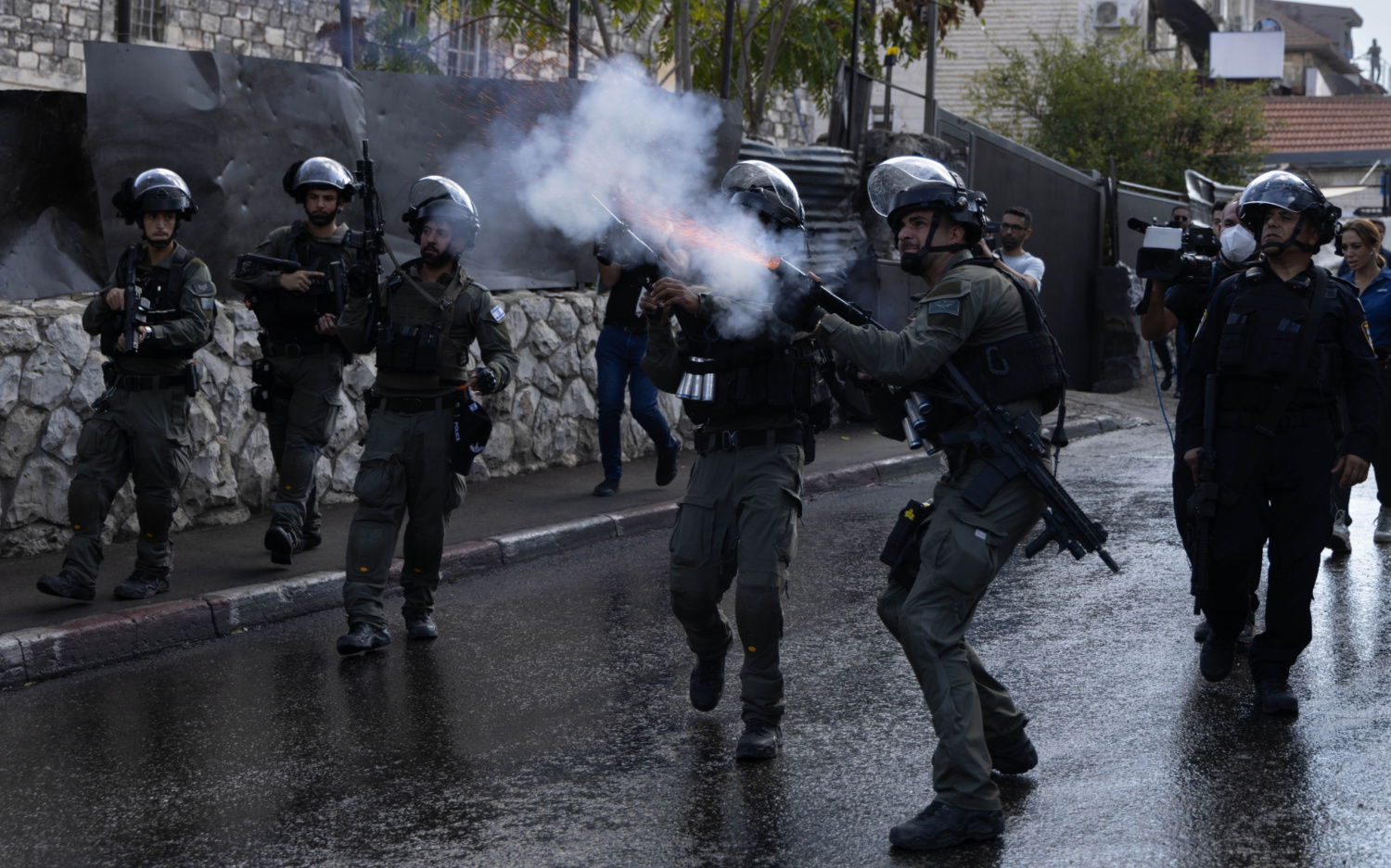 Israeli soldiers firing tear gas at Palestinian worshippers.