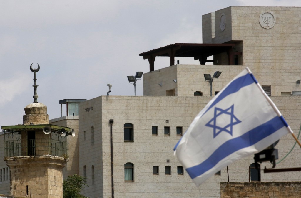 An Israeli flag is pictured at an Israeli settlement in Hebron on 14 June (AFP)