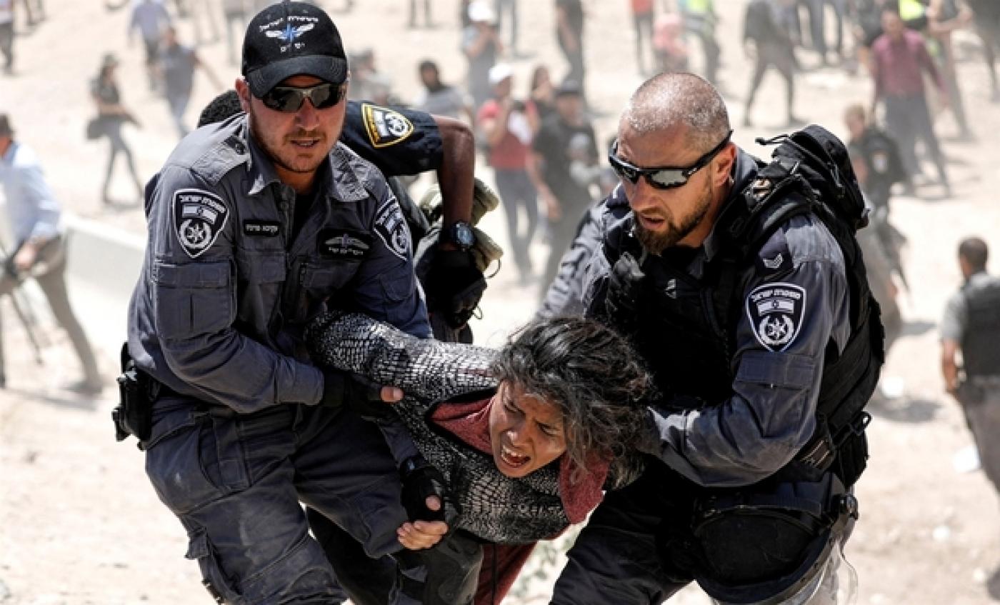 Des policiers israéliens arrêtent une fillette palestinienne à Khan al-Ahmar, en Cisjordanie, le 4 juillet 2018 (Reuters)