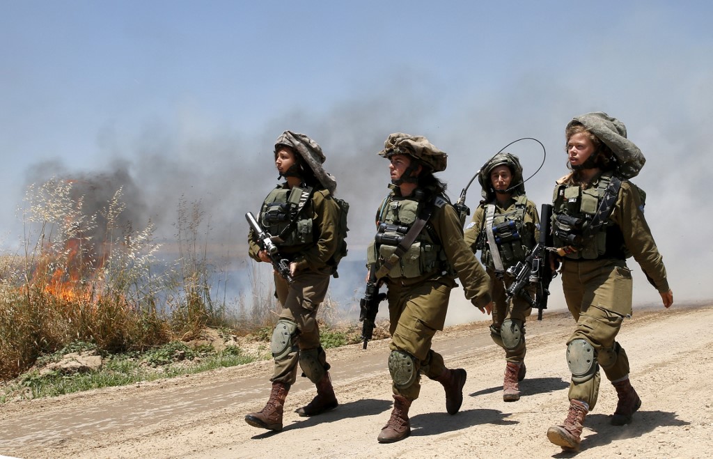 Israeli soldiers patrol the area near the Gaza fence on 14 May 2018 (AFP)