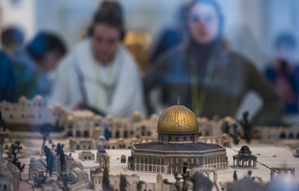 Visitors look at a model Dome of the Rock at the Jewish Museum in Berlin in 2017 (AFP)