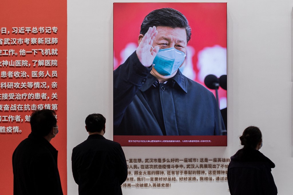 A picture of Chinese President Xi Jinping is displayed at an exhibition about China’s fight against Covid-19 in Wuhan on 15 January 2021 (AFP)