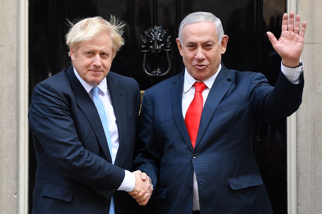 British Prime Minister Boris Johnson greets Israeli Prime Minister Benjamin Netanyahu in central London in September 2019 (AFP)