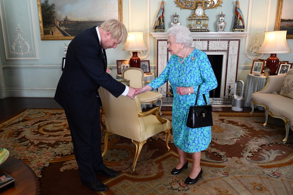 Queen Elizabeth II welcomes Johnson in Buckingham Palace on 24 July (AFP)