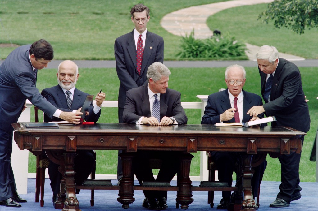 Israeli Prime Minister Yitzhak Rabin and Jordan’s King Hussein sign the 1994 peace treaty in Washington as US President Bill Clinton looks on (AFP)