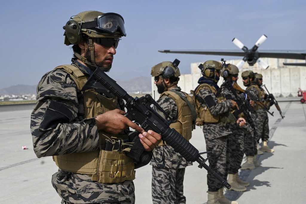 Taliban forces stand guard at the airport in Kabul on 31 August 2021 (AFP)