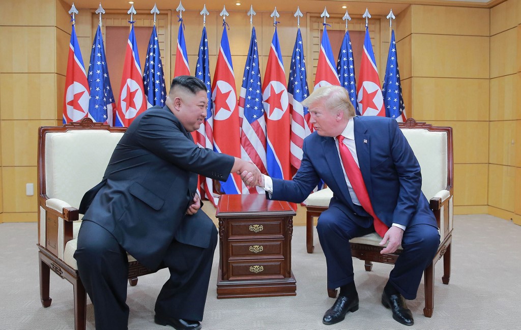 North Korean leader Kim Jong Un and US President Donald Trump shake hands during a meeting in the DMZ on 30 June (KCNA VIA KNS/AFP)