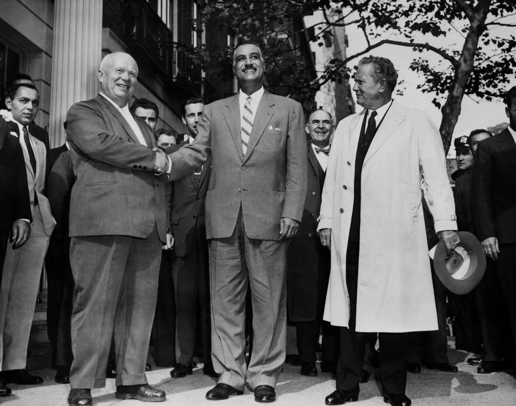 General Secretary of the Central Committee of the Communist Party of the Soviet Union Nikita Khrushchev (L) shakes hand with President of Egypt Gamal Abdel Nasser (C) as President of Yugoslavia Josip Broz Tito (R) looks on, in September 1960, at the United Nations, New York. 