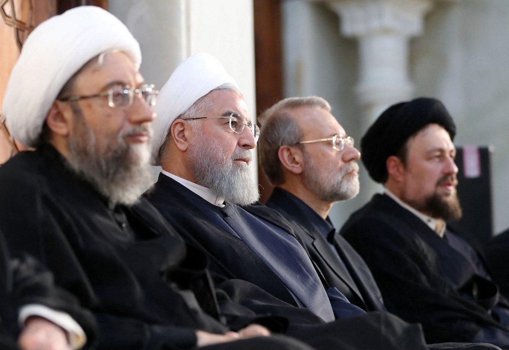 A handout picture provided by the office of Iran's Supreme Leader Ayatollah Ali Khamenei on June 4, 2018, shows (L to R) Iranian judiciary chief Sadegh Larijani, Iranian president Hassan Rouhani, parliament speaker Ali Larijani and Hassan Khomeini, the grandson of the founder of the Islamic Republic, Ayatollah Ruhollah Khomein, during a ceremony on the occasion of 29th anniversary Khumeini's death at his Shrine in southern Tehran
