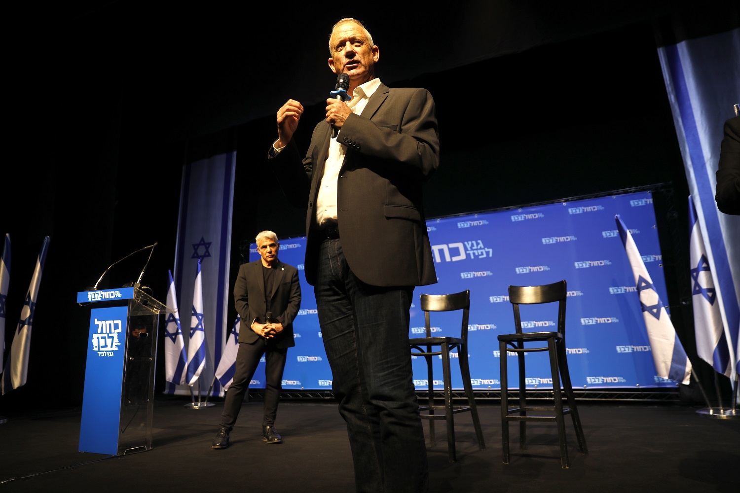 Yair Lapid (left) looks on during a speech by Benny Gantz in Beersheva in March 2019 (AFP) 