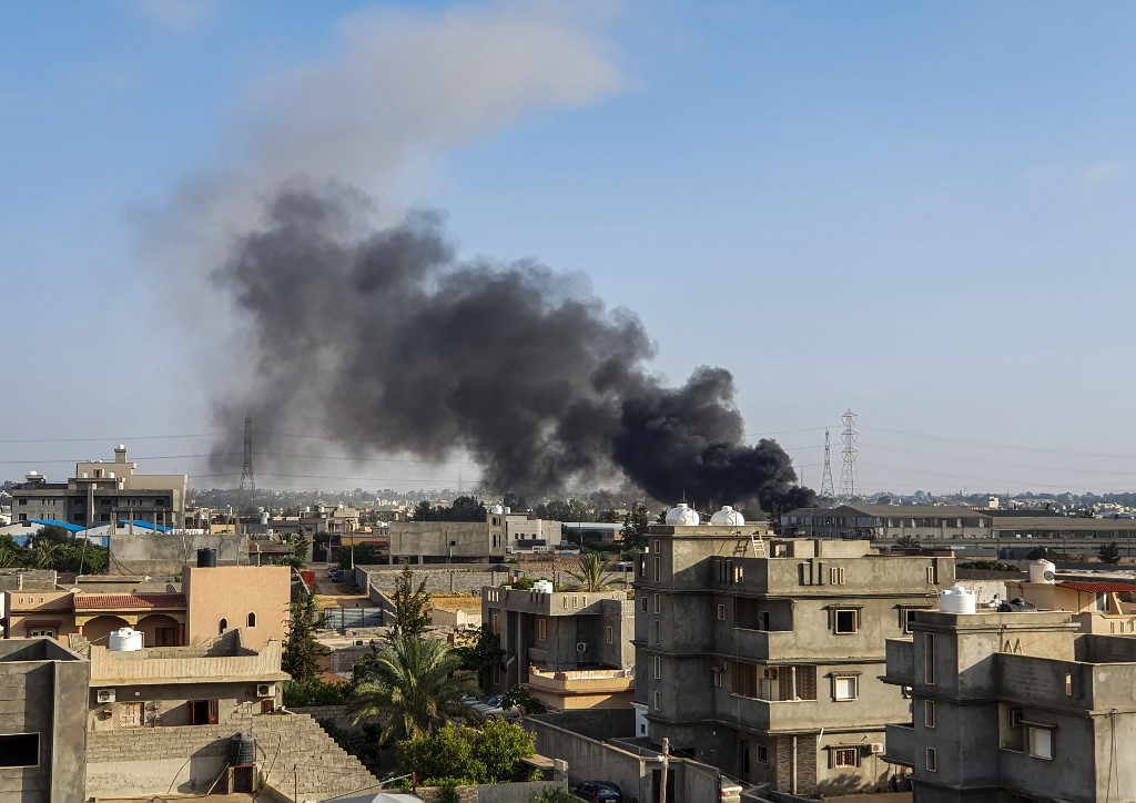 Smoke rises south of the Libyan capital Tripoli after an air strike by forces loyal to Khalifa Haftar in June 2019 (AFP)