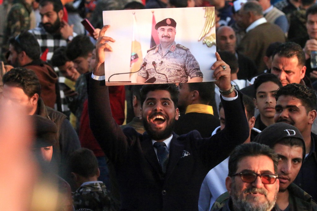 Supporters of Libyan military strongman Khalifa Haftar protest against Turkish intervention in the country’s affairs in Benghazi on 14 February (AFP)