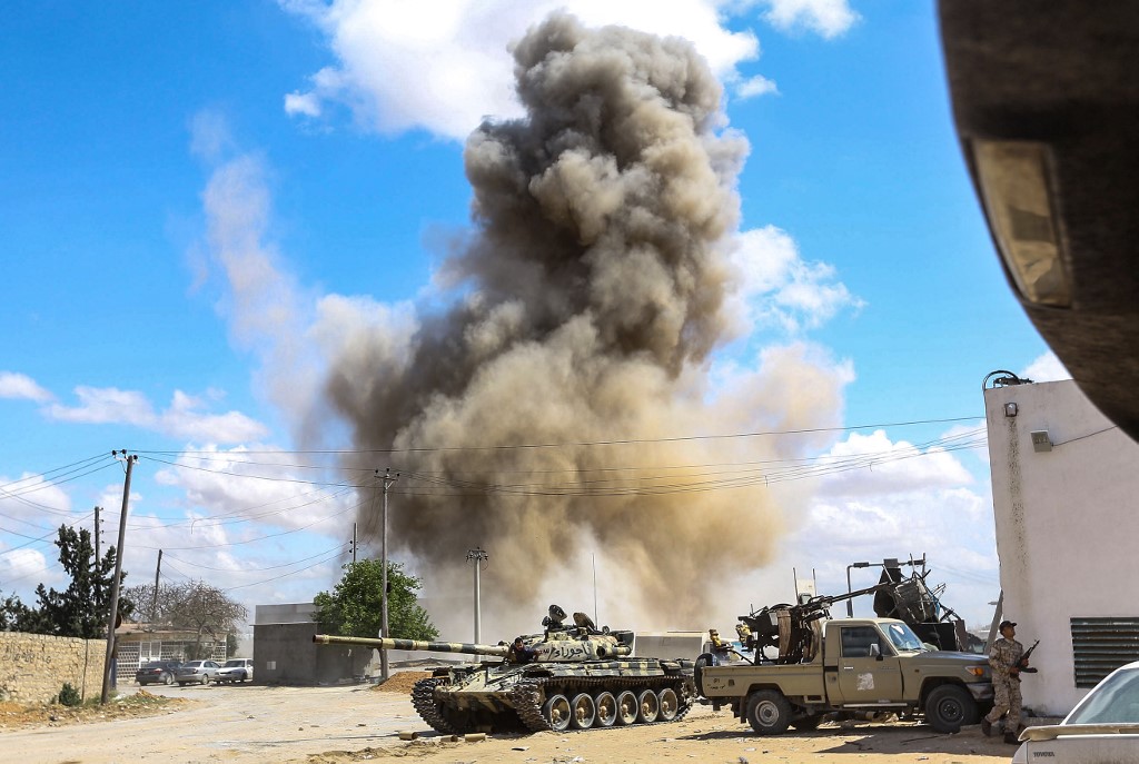 Smoke rises from an air strike in Wadi Rabie, Libya, on 12 April (AFP)